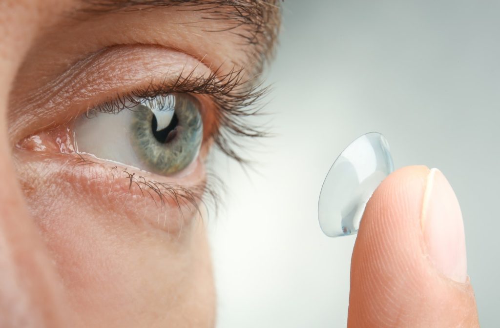 Close up of women inserting contact lenses into eyes