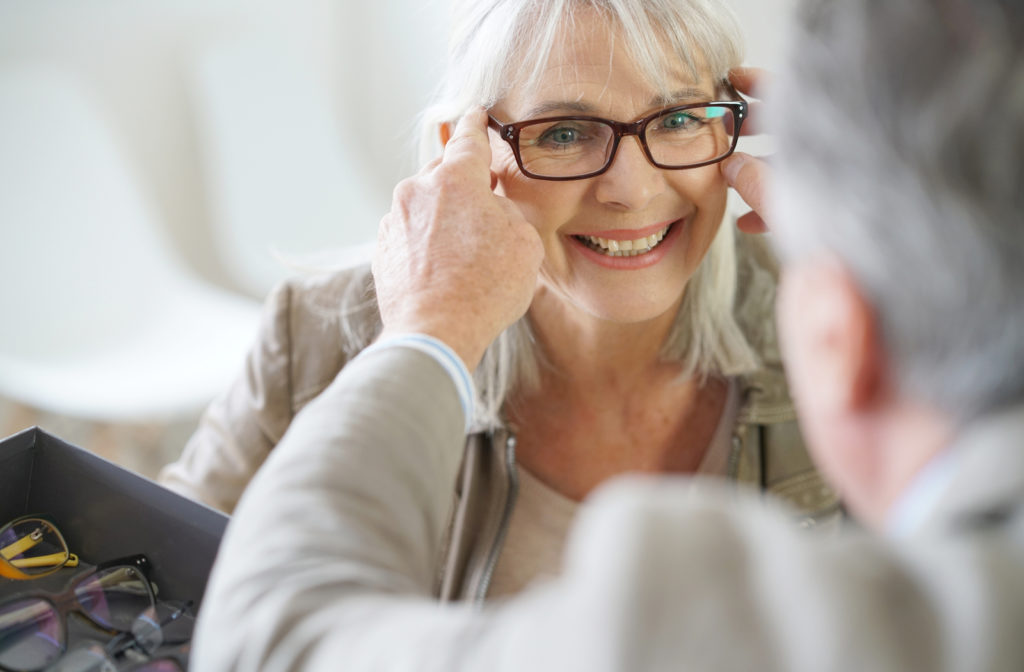 women getting glasses after eye exam from eye doctor