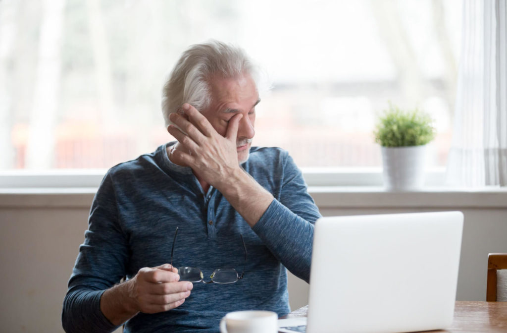 a man with dry eye rubs his eye for relief