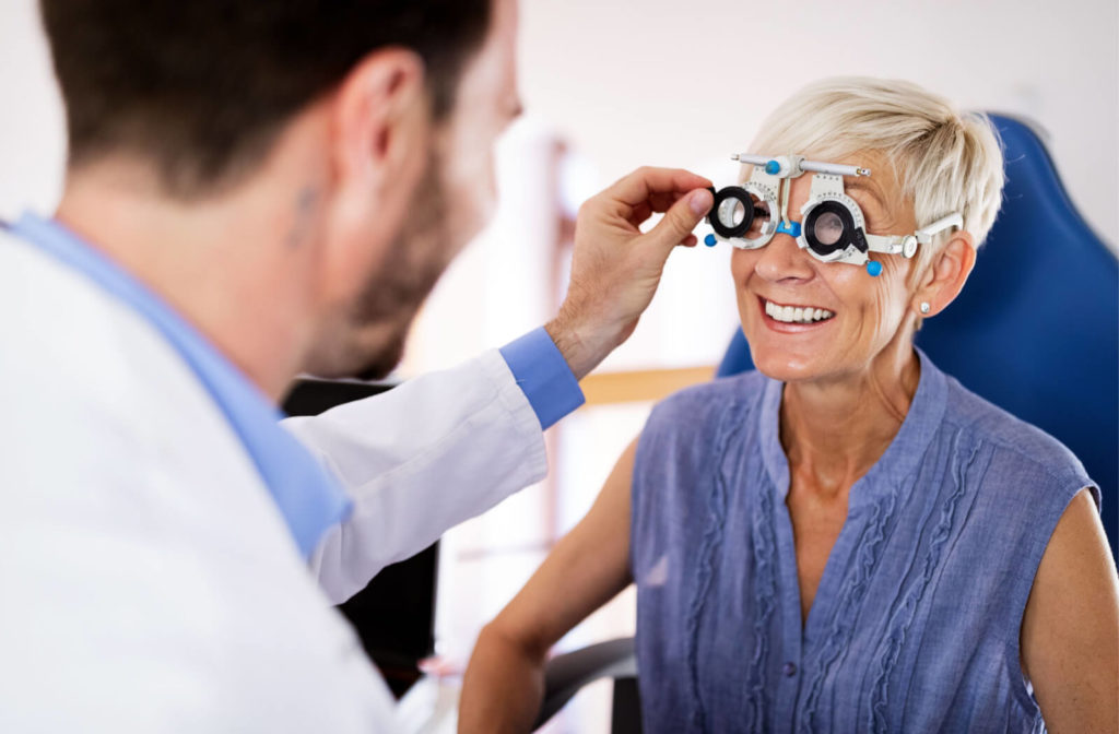 Middle-aged woman being fitted for a new pair of glasses by an optometrist