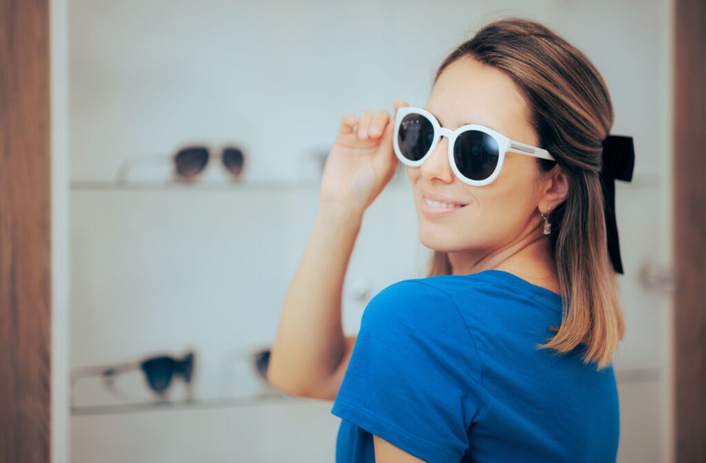 Happy woman trying on glasses at the optometrist's office