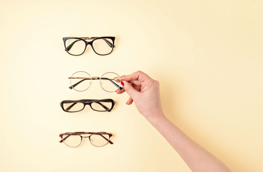 Four pairs of trendy glasses on a yellow background